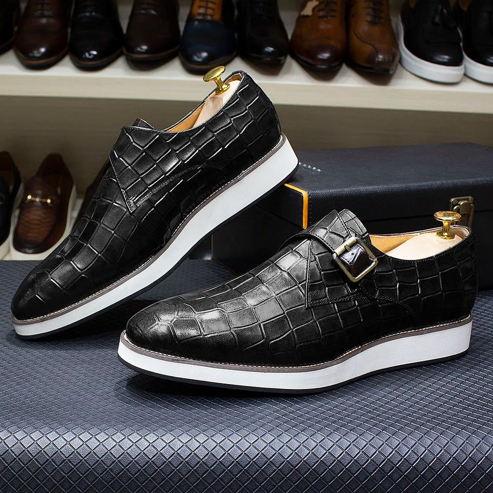 Close-up of crocodile pattern texture on handcrafted leather monk strap dress shoes with metal buckles