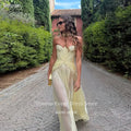 Yellow chiffon gala gown with elegant pleats and sweetheart neckline.