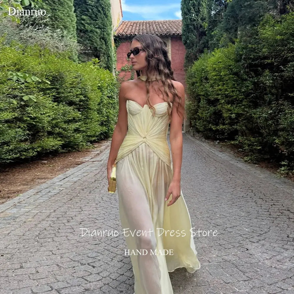 Yellow chiffon gala gown with elegant pleats and sweetheart neckline.