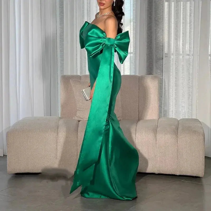 Strapless satin dress in rich emerald, highlighting shoulders and creating a stunning silhouette.