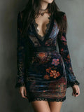 Deep V-neck velvet dress with lace accents and floral pattern in rich color.