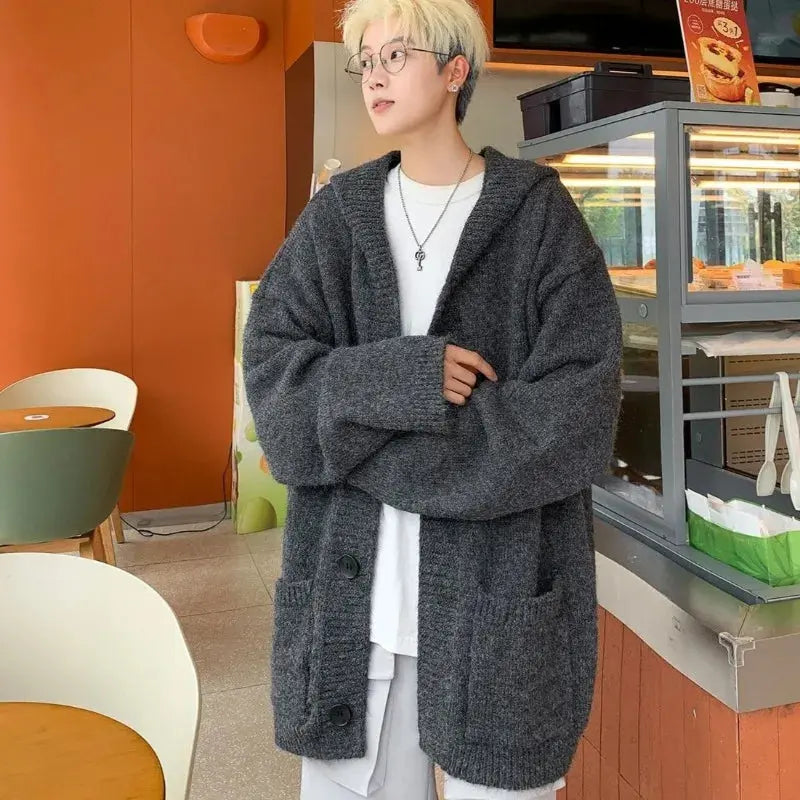 Warm and versatile hooded cardigan ideal for layering in autumn and spring seasons.