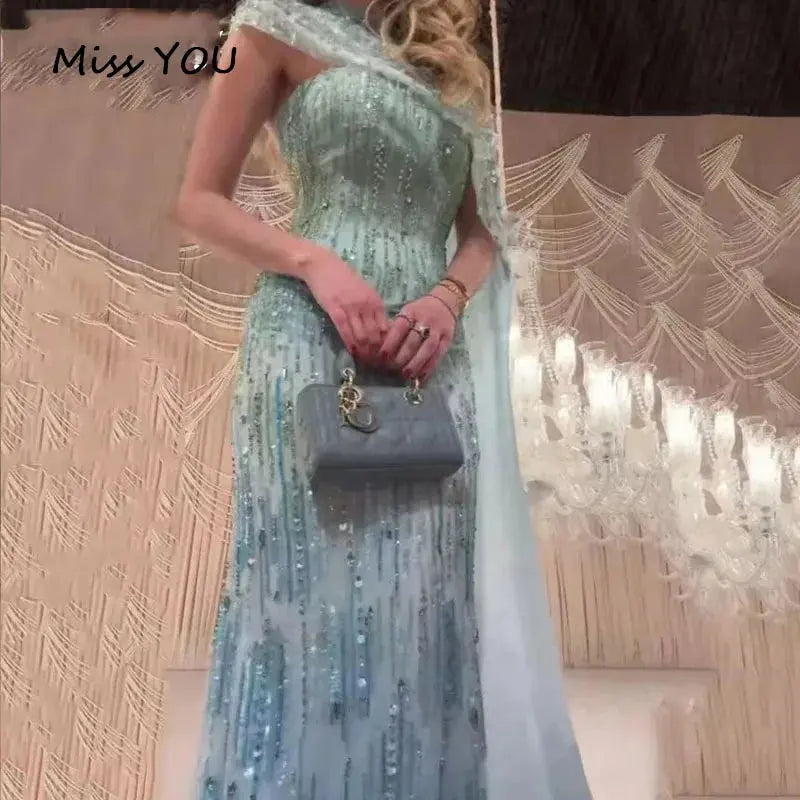 One-shoulder design of the blue mermaid gown showcasing elegant craftsmanship.