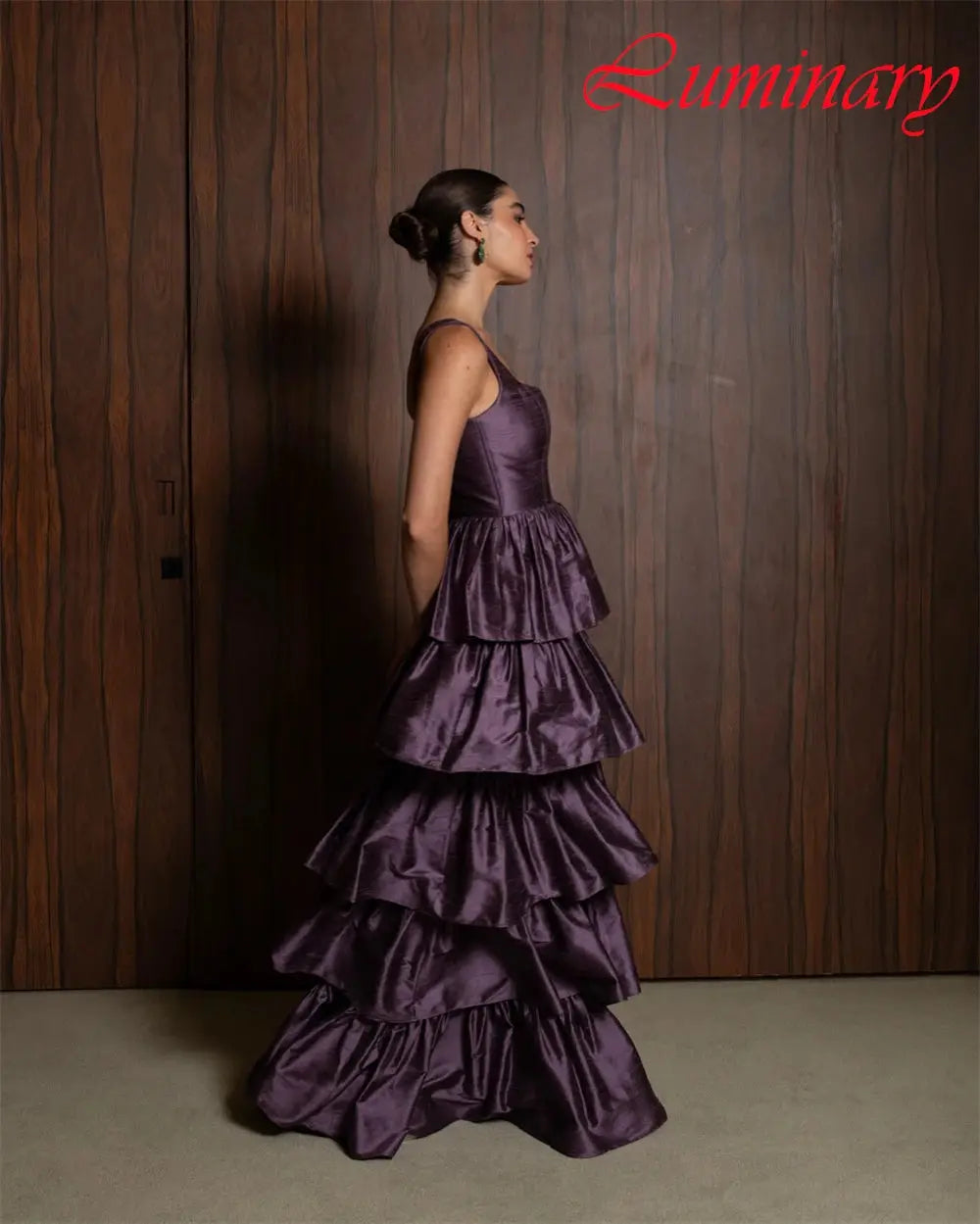 Full-length view of the sleeveless satin gown, blending classic and modern design elements beautifully.