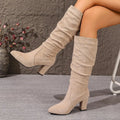 Chic black ankle boots with pointed toe and thick heel for stylish autumn wear.