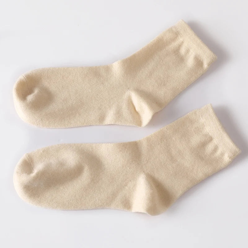 Cashmere socks displayed with seasonal decor, enhancing their winter warmth appeal.