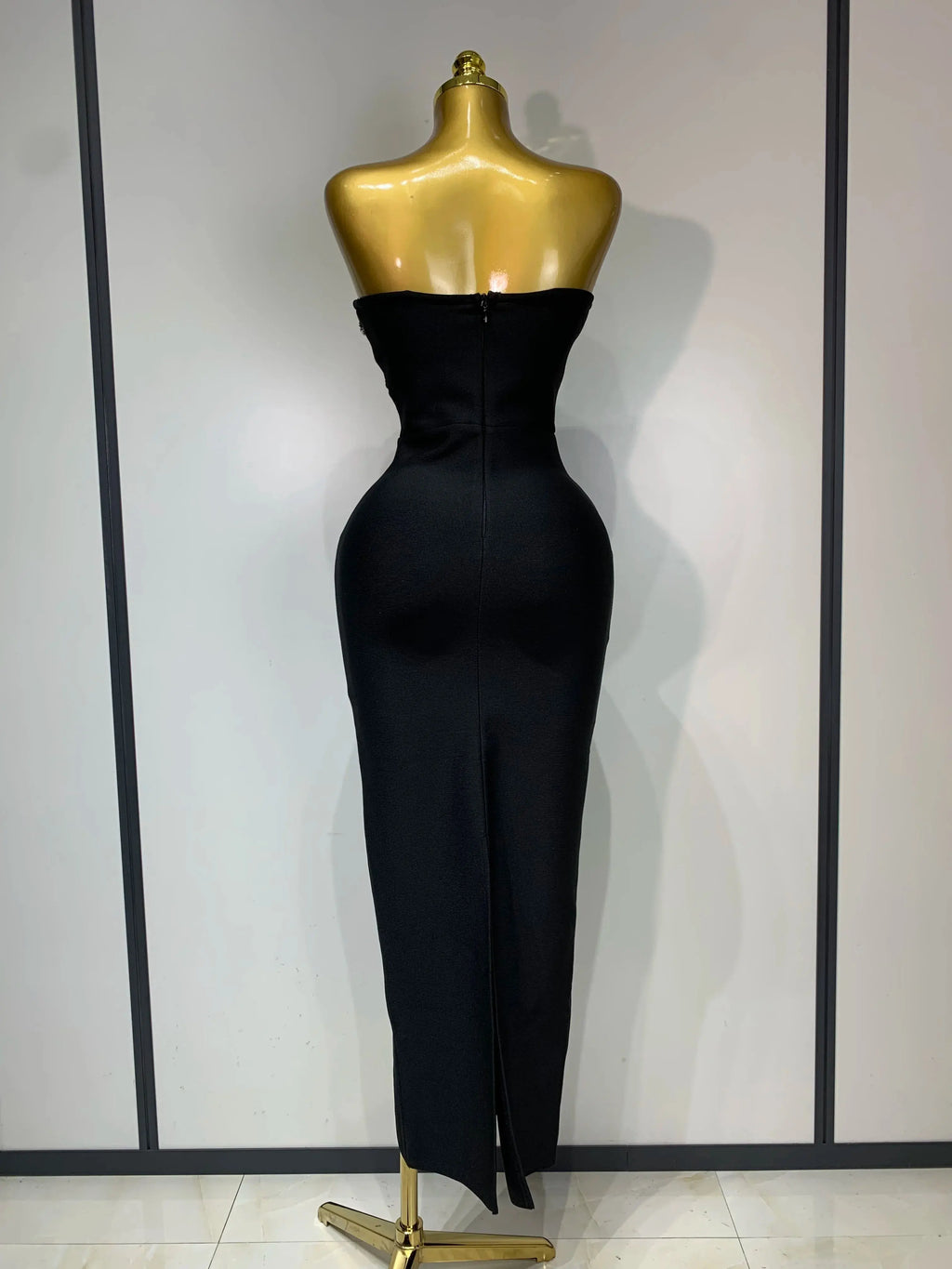 Model wearing the glamorous strapless evening gown, highlighting its silhouette.