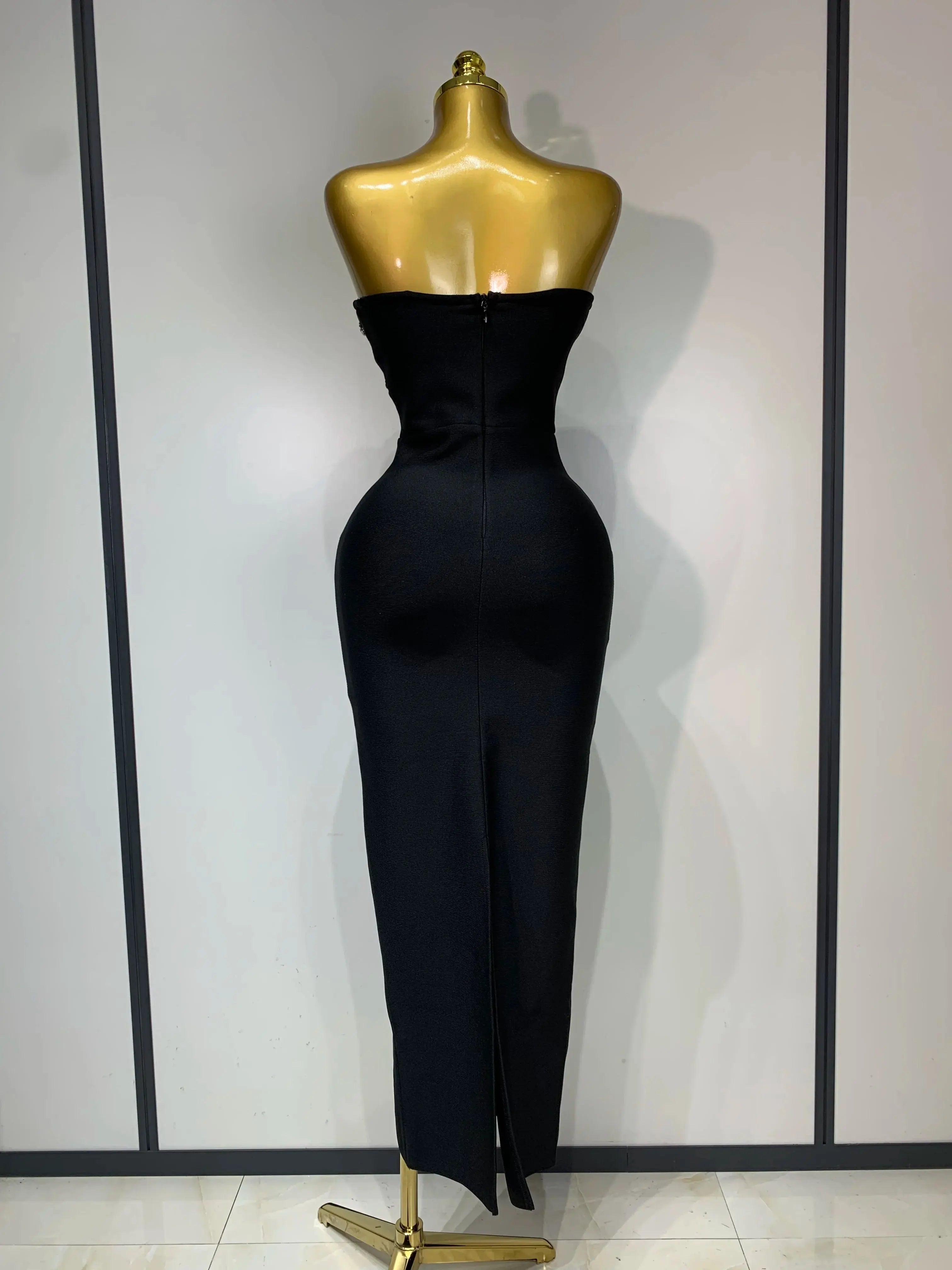 Model wearing the glamorous strapless evening gown, highlighting its silhouette.