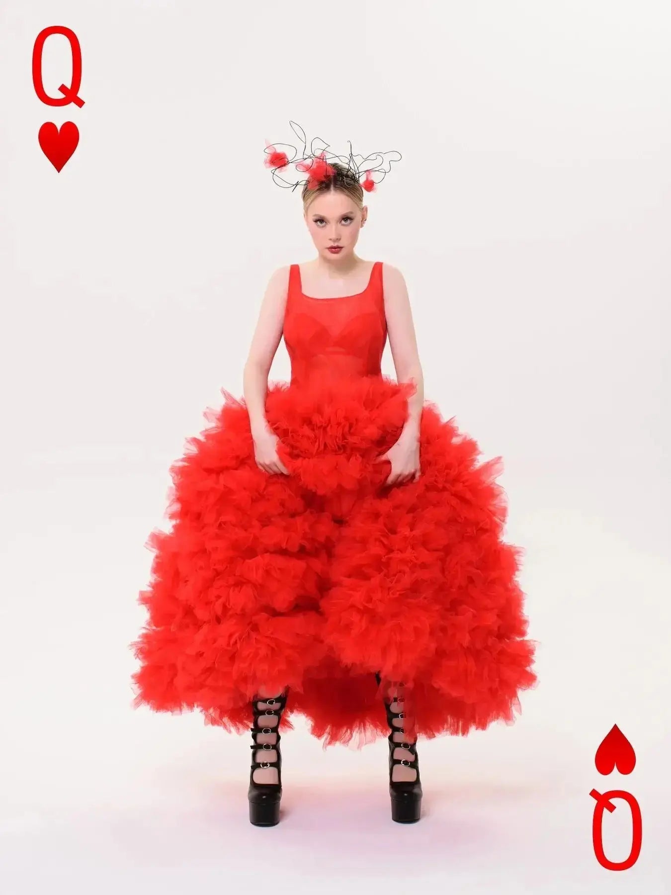 Model wearing a luxurious red tulle gown, exuding confidence and style.