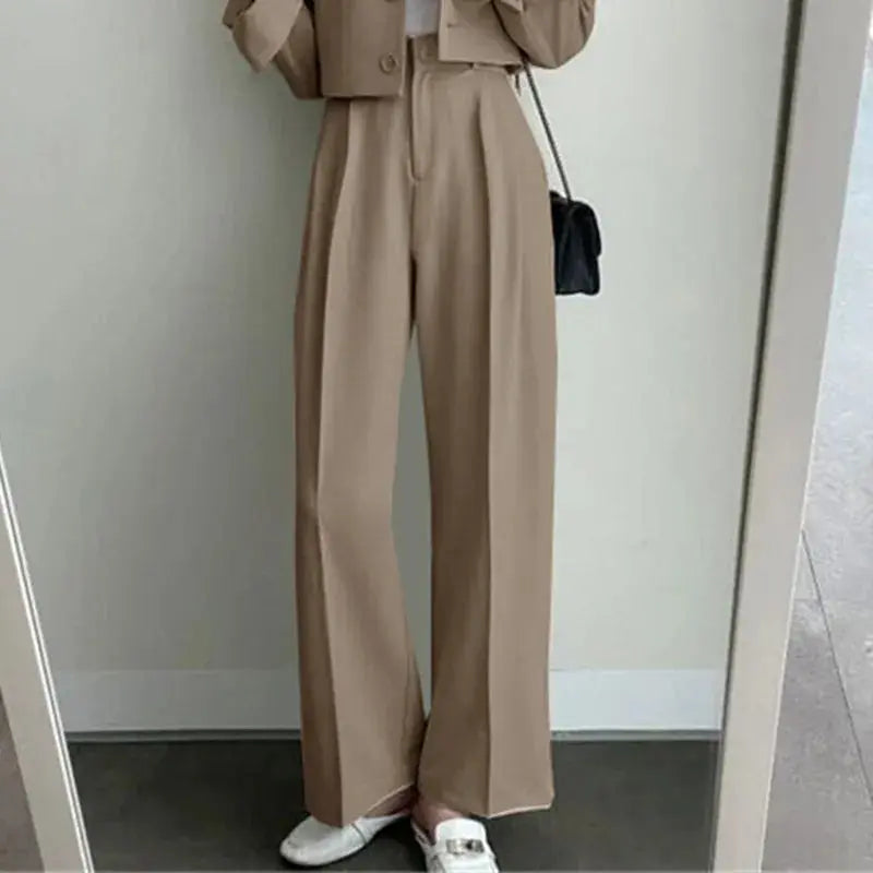 Model confidently presenting in the power suit during a business meeting.