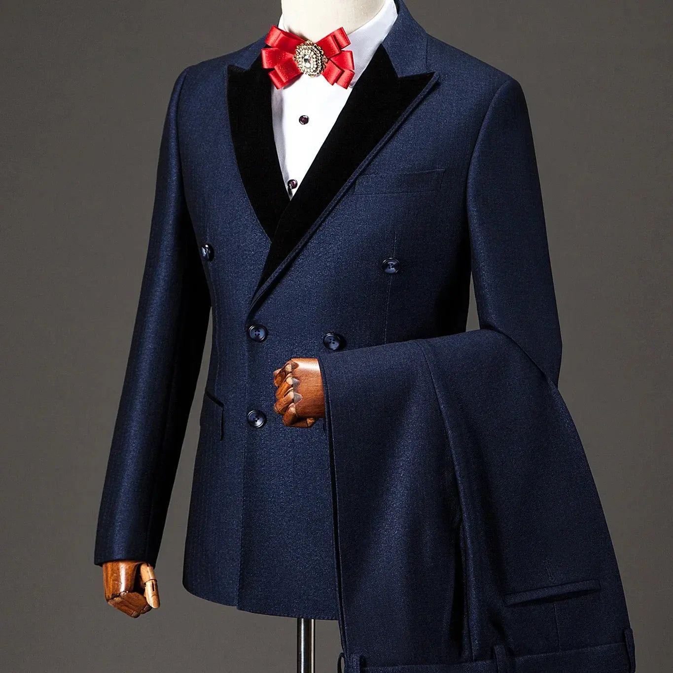 Model wearing a tailored navy nightsuit, exuding confidence at a formal event.