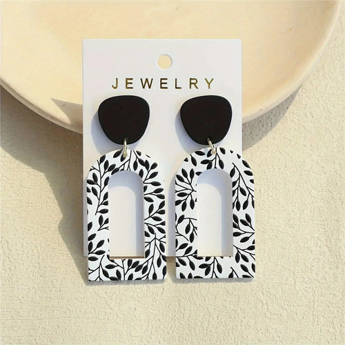 Whispering Leaves Drop Earrings in light acrylic, showcasing a geometric design and subtle elegance.