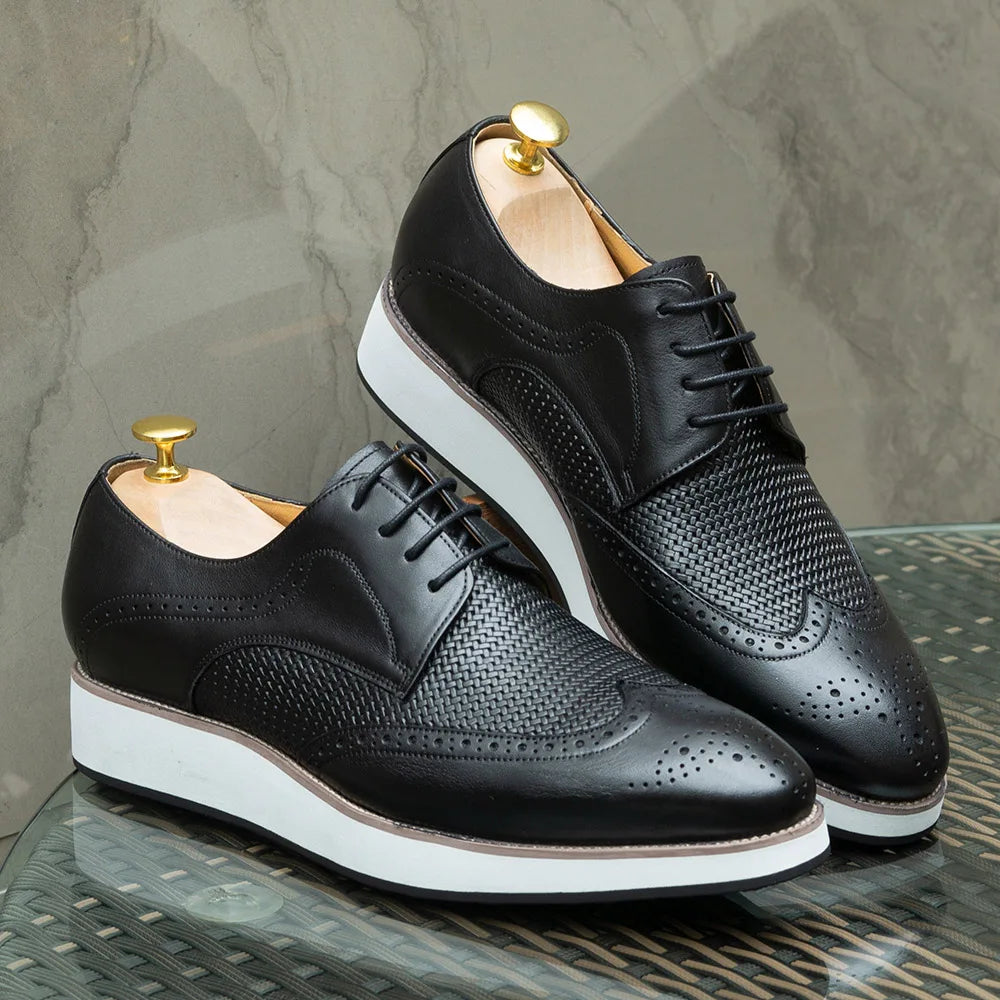 Close-up of wingtip brogue detailing on genuine leather dress shoes showing premium craftsmanship