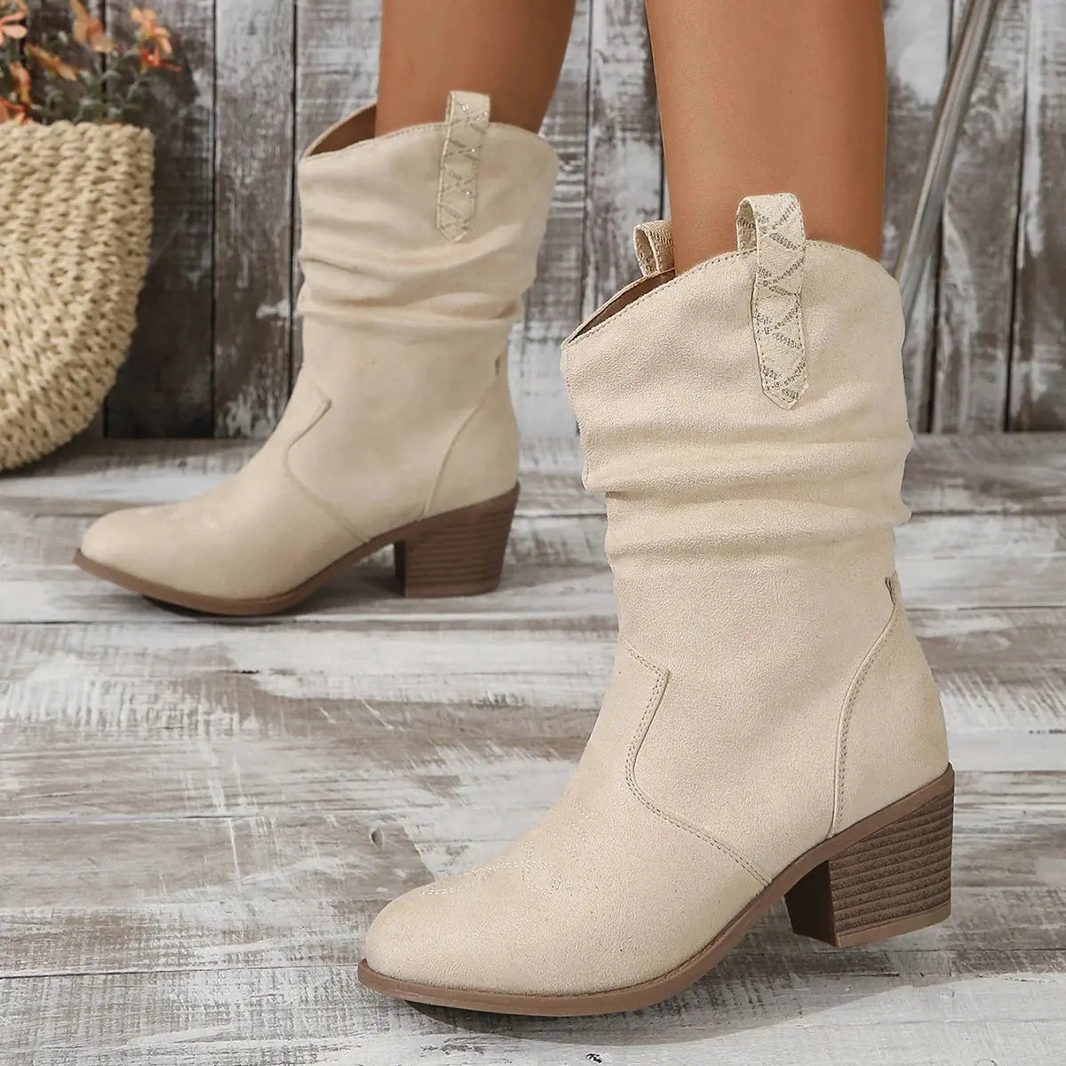 Brown embroidered Western boots with chunky heel and mid-calf height shown on white background