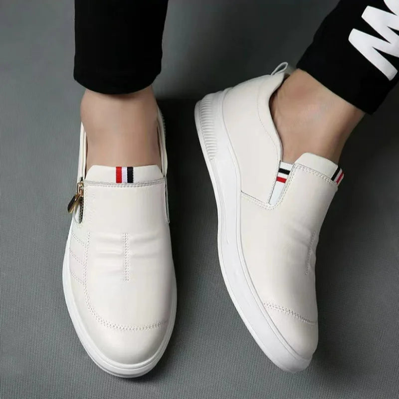Durable rubber outsole on versatile white sneaker loafers.