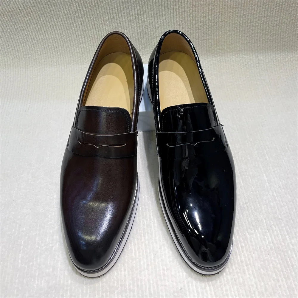 Elegant black patent leather pointed loafers with shallow profile and rubber outsole