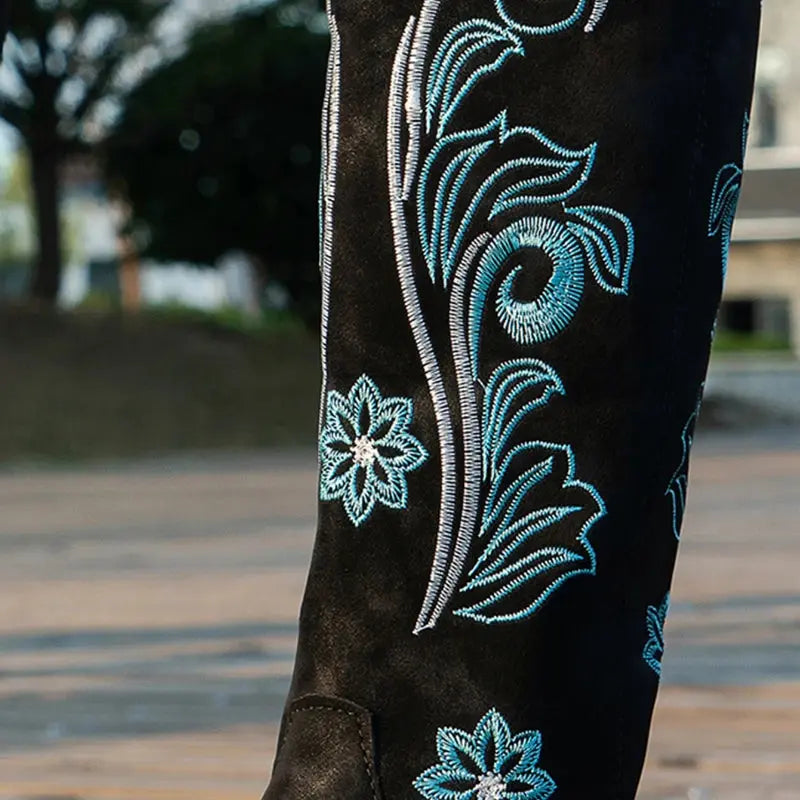 Western style boots with decorative embroidery, square heel, and all-weather waterproof design