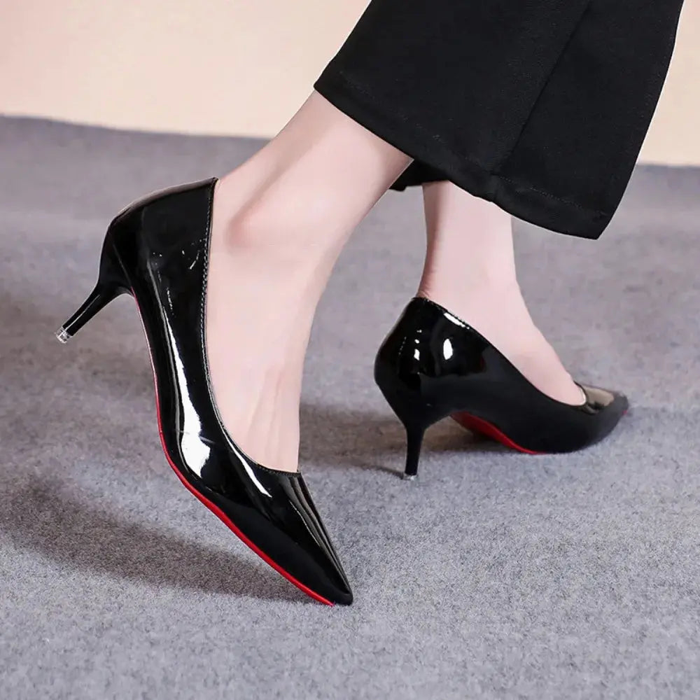Model wearing black heels at a business meeting, demonstrating versatility.