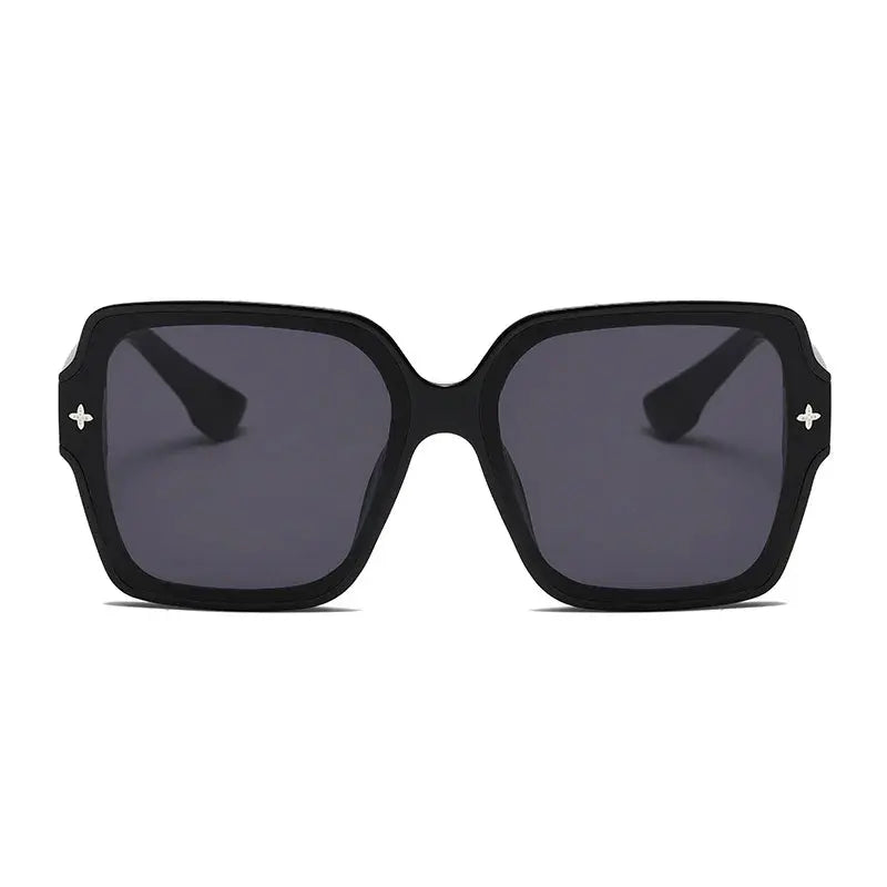 Durable lightweight sunglasses resting on a café table under sunlight.