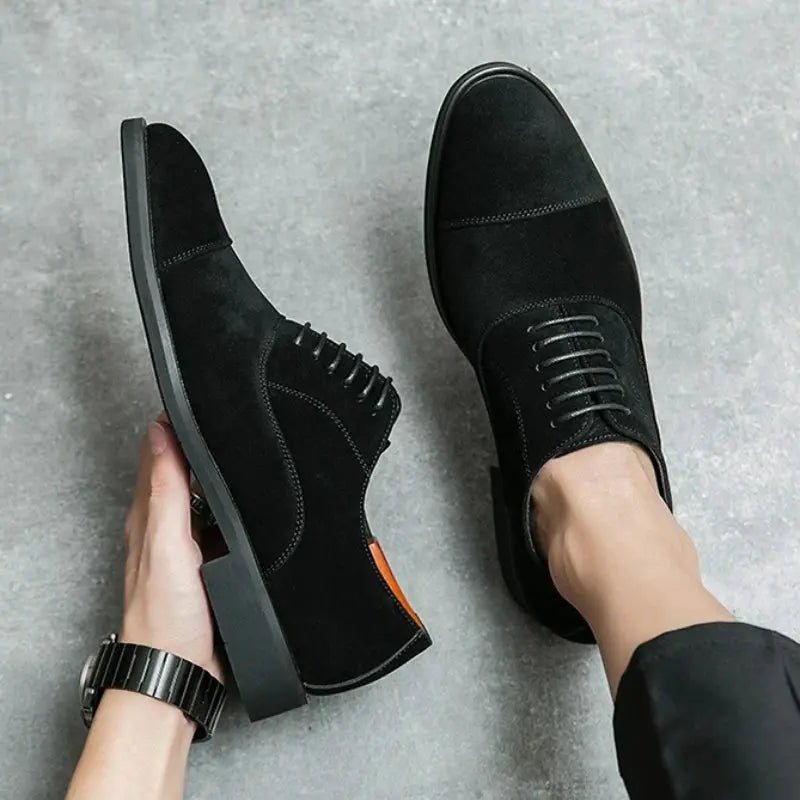 Brown suede oxfords paired with formal attire, perfect for business meetings and elegant events.