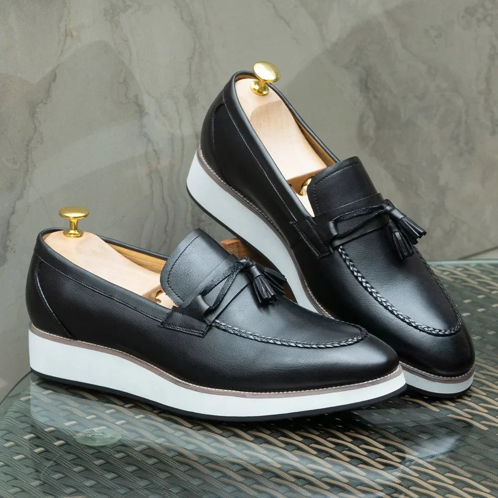 Pair of handcrafted leather tassel loafers with shoe horn showing easy slip-on entry design