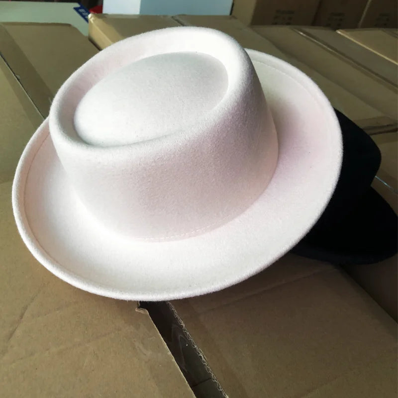 Black fedora paired with a chic jacket for a modern look.