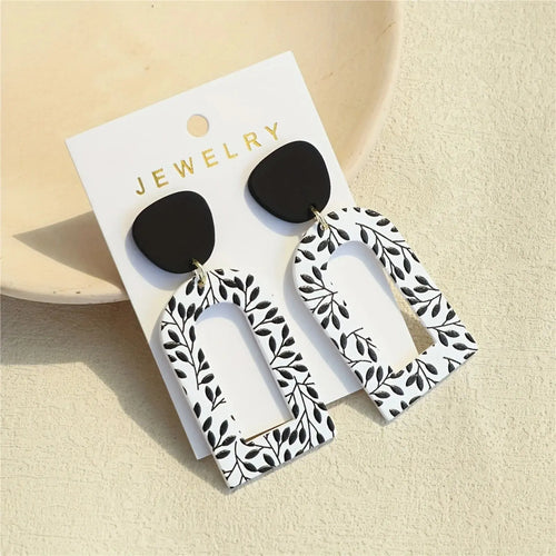 Close-up of Whispering Leaves Drop Earrings highlighting the stainless steel charm and lightweight feel.
