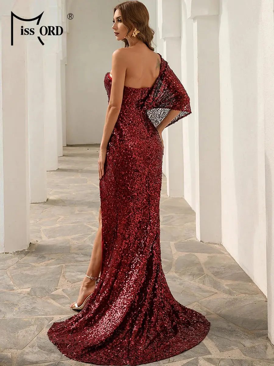 Detail shot of the gown's luxurious fabric and intricate sequin placement.