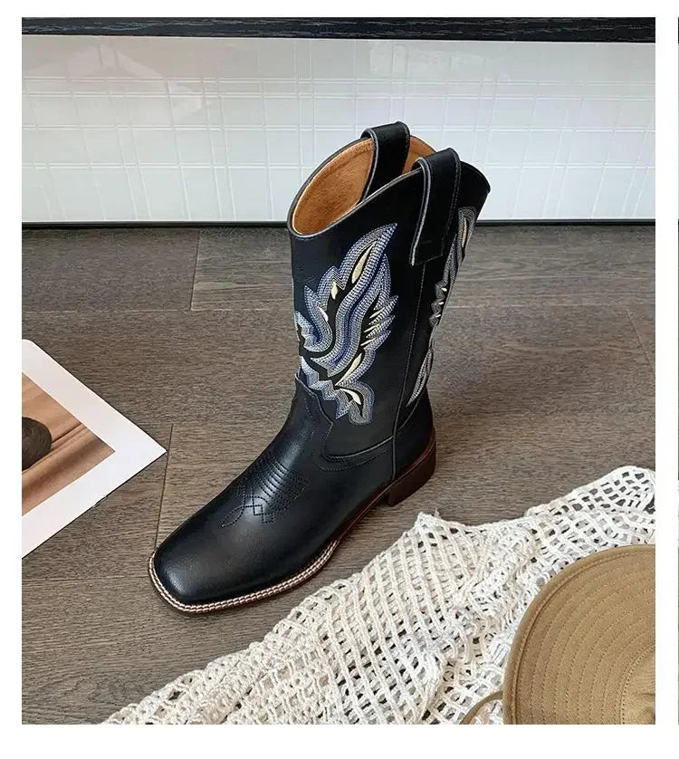 Mid-calf slip-on boots with hand-inspired embroidery and classic cowboy styling