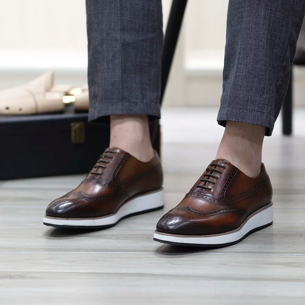 Side view of classic leather Oxford shoes with wing tip pattern and cushioned insole