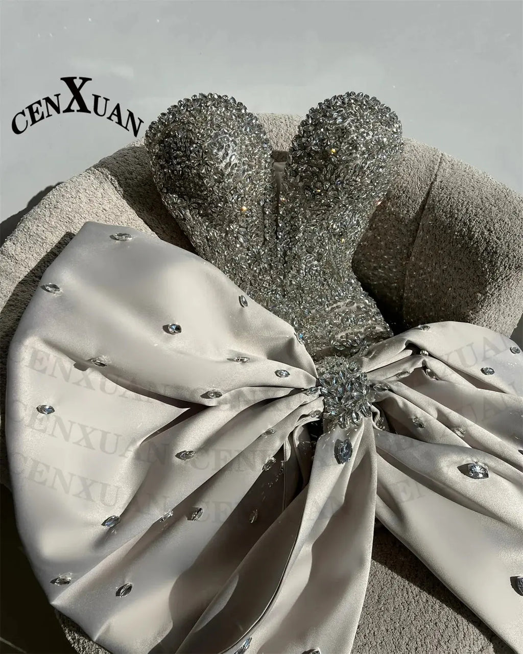 Close-up of hand-applied rhinestones on the Rhinestone Bow Gala Dress, showcasing exquisite detailing.