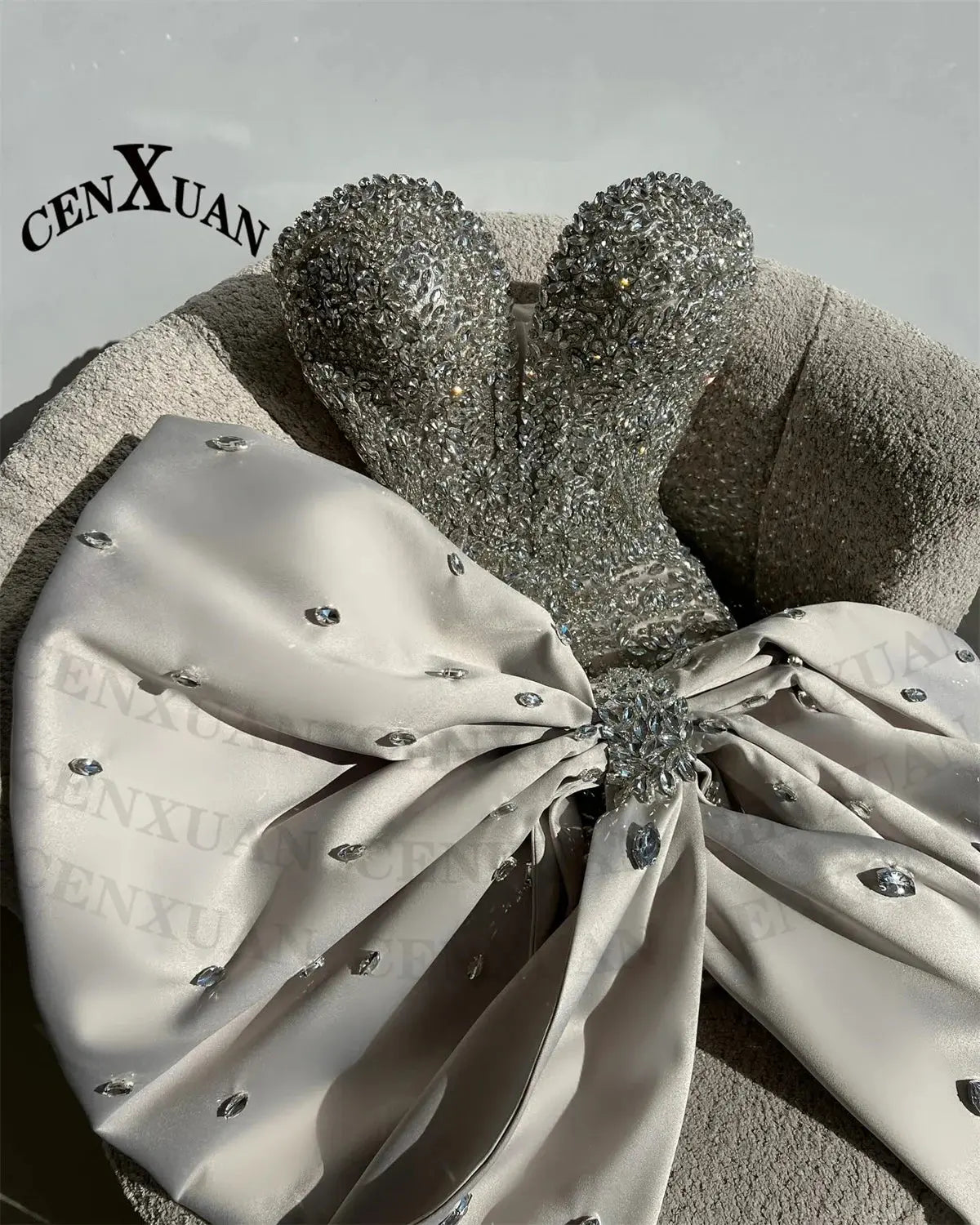 Close-up of hand-applied rhinestones on the Rhinestone Bow Gala Dress, showcasing exquisite detailing.