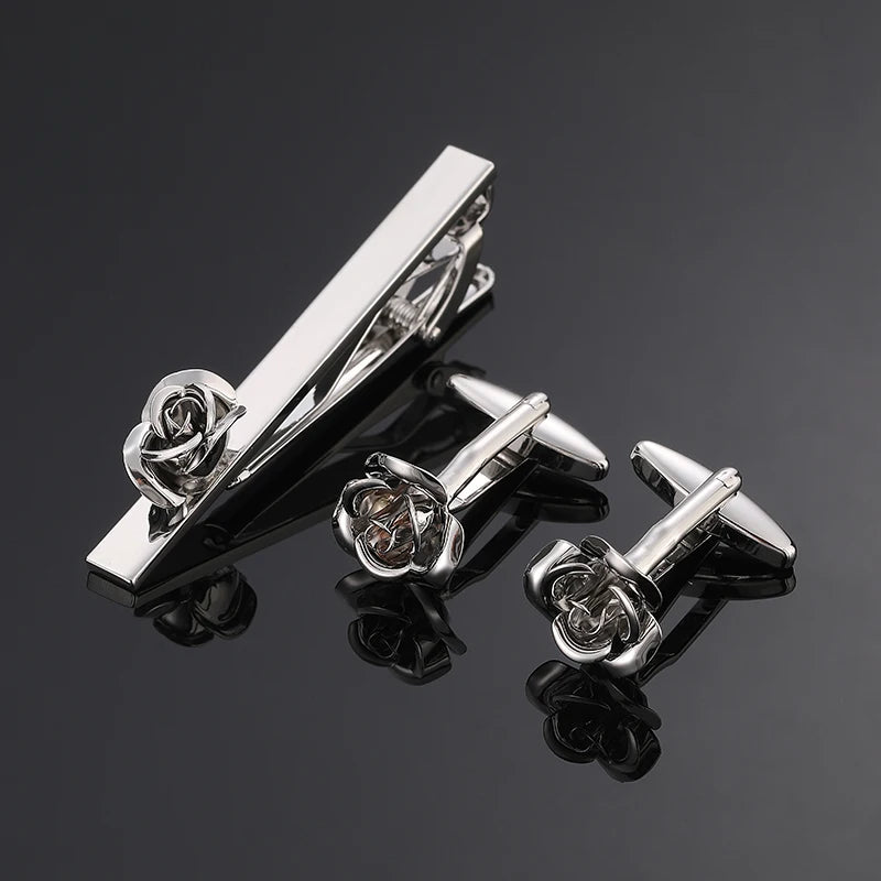 Elegant cufflinks with rose metal patterns, catching the light beautifully.