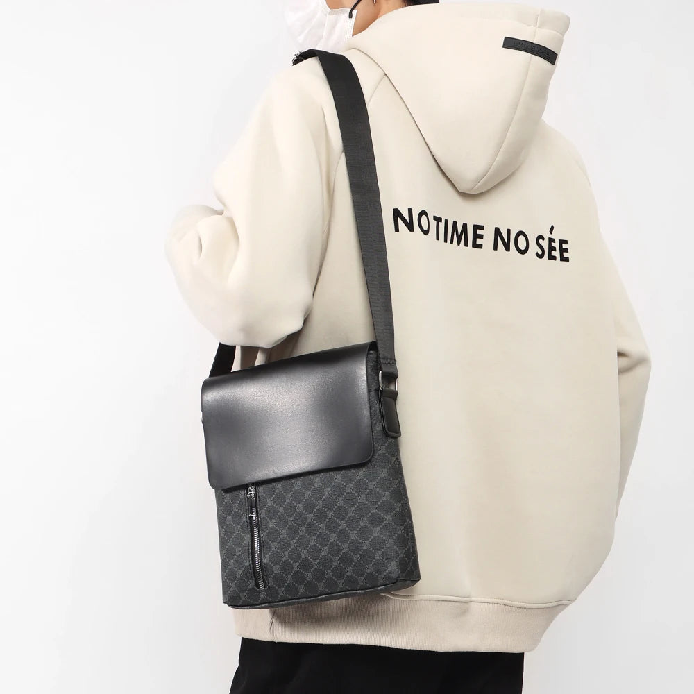 Compact black messenger bag with multiple compartments for organizing phone, wallet, and keys