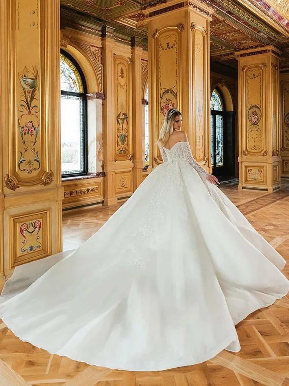 Off-shoulder design of the Enchanting Elegance Gown showcasing luxurious organza and romantic lace.