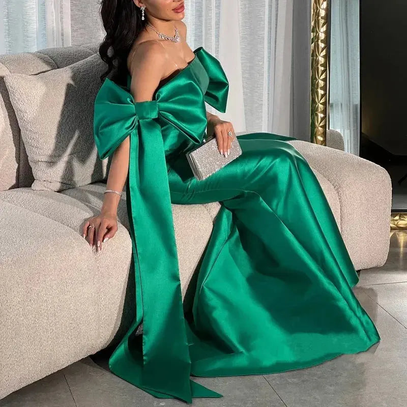 Enchanting emerald gown in luxurious satin, showcasing a strapless design and elegant silhouette.