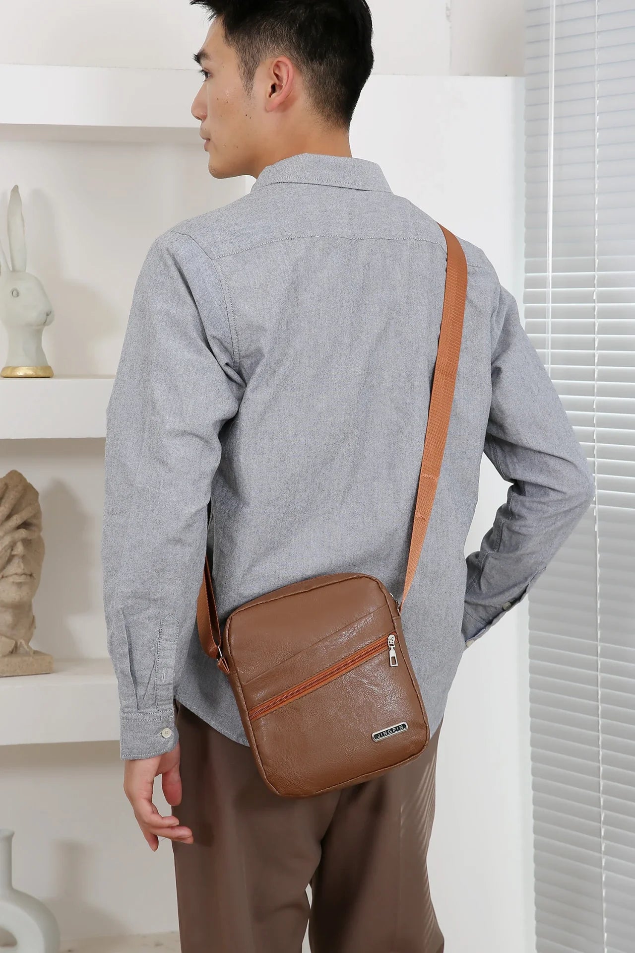 Versatile messenger bag with bucket silhouette offering ample storage in compact design