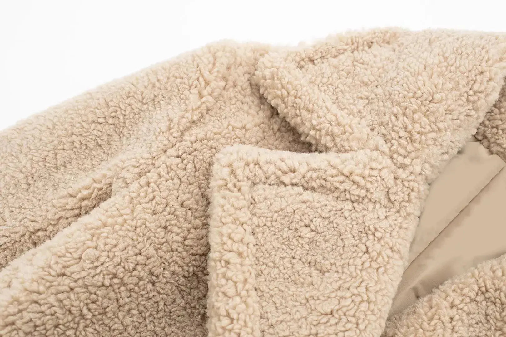 Detail shot of the coat's durable polyester material, perfect for cold weather comfort.