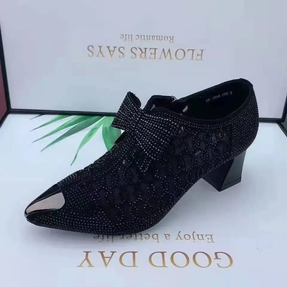 Black pointed heels with shimmering rhinestones, designed for confident entrances.