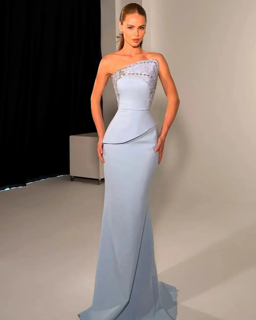 Elegant strapless mermaid gown in luxurious jersey fabric with rhinestone beading.
