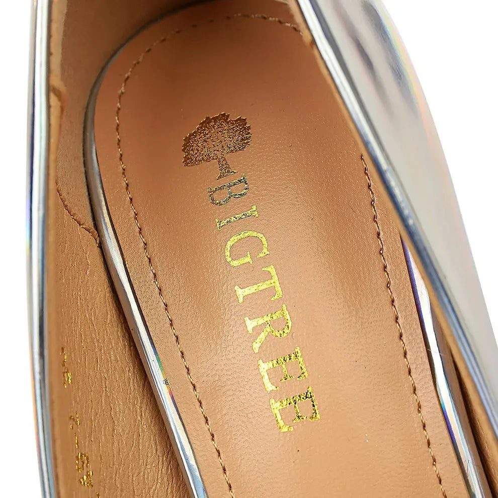 Back view of green stilettos showcasing the rubber sole for comfort.