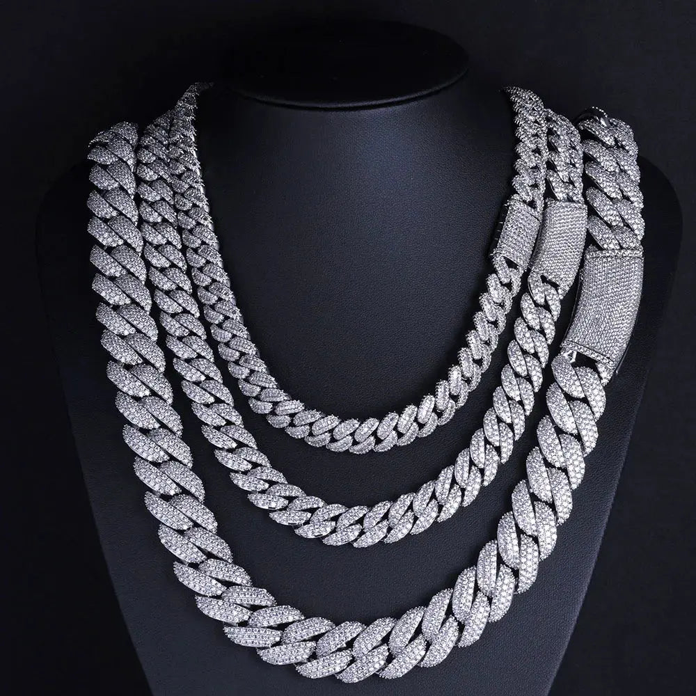 Silver and gold iced out Cuban chains displayed together showing 13mm width and brilliant stone setting