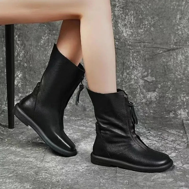 Mid-calf boots with medium heel offering stability on slippery sidewalks
