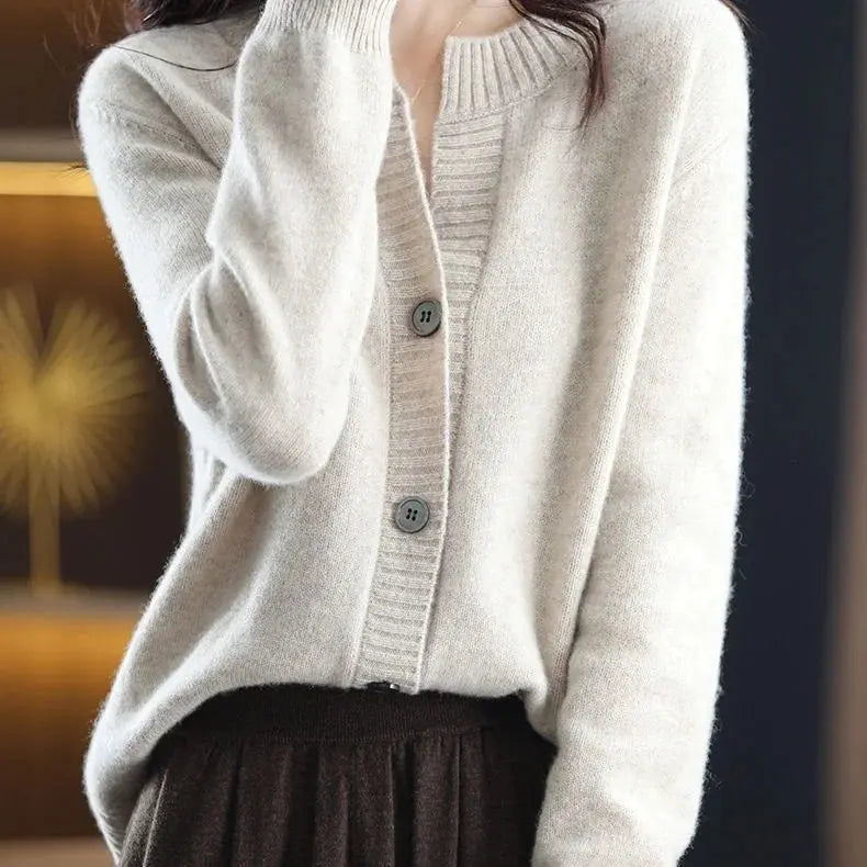 Versatile cardigan styled for office wear with a blouse underneath.