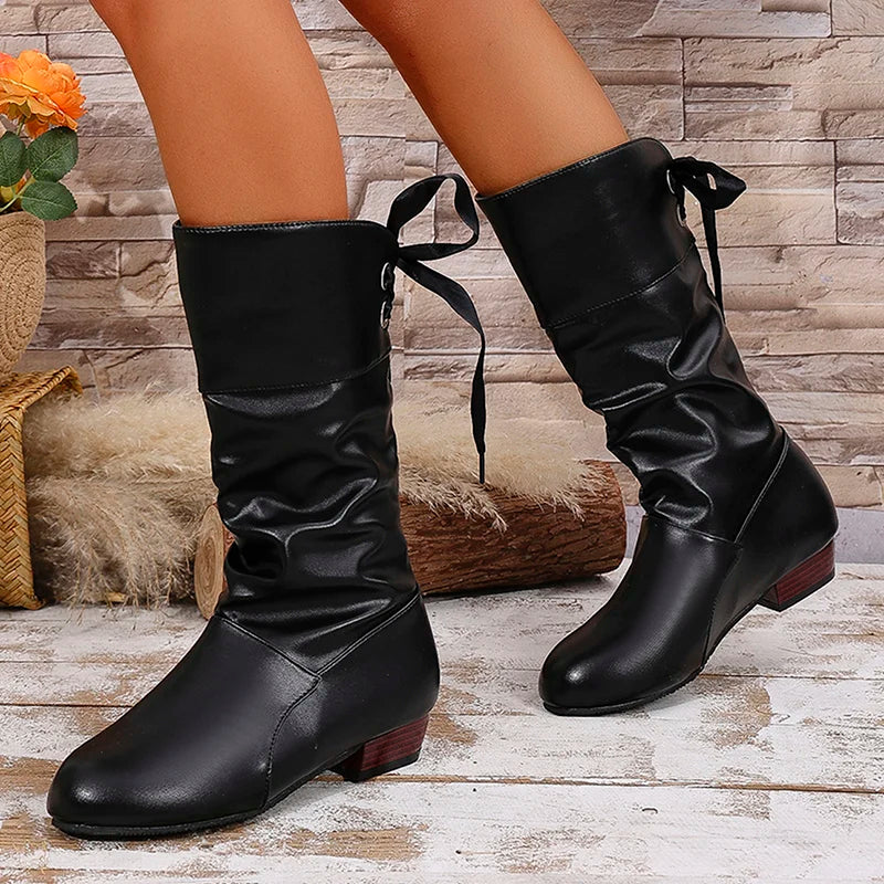Versatile mid-calf boots in textured black leather perfect for fall styling