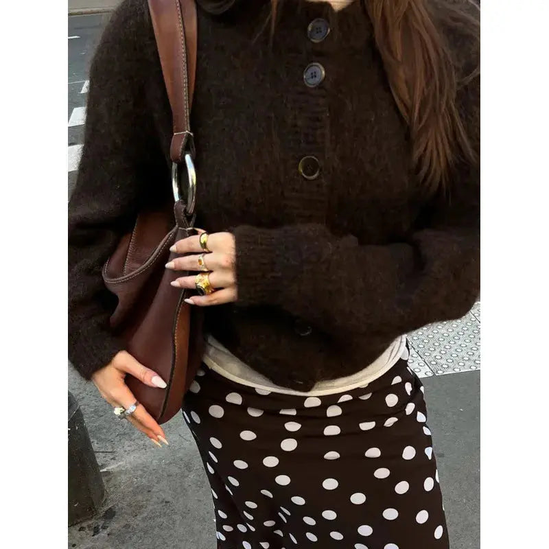 Textured knit sweater with playful fringe detail, perfect for a stylish autumn ensemble.