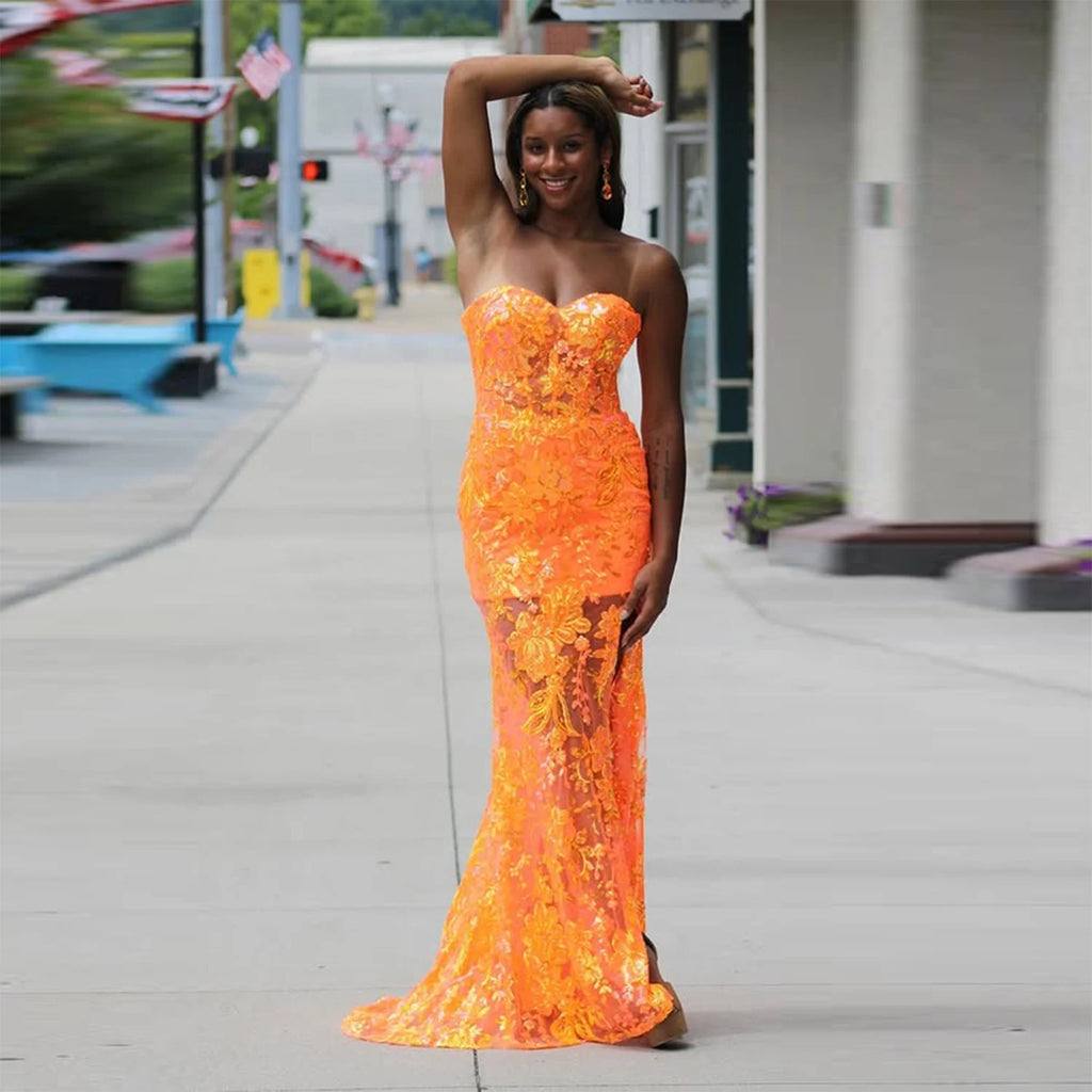 Sunset Glow Strapless Gown in orange lace, showcasing a mermaid silhouette and sweetheart neckline.