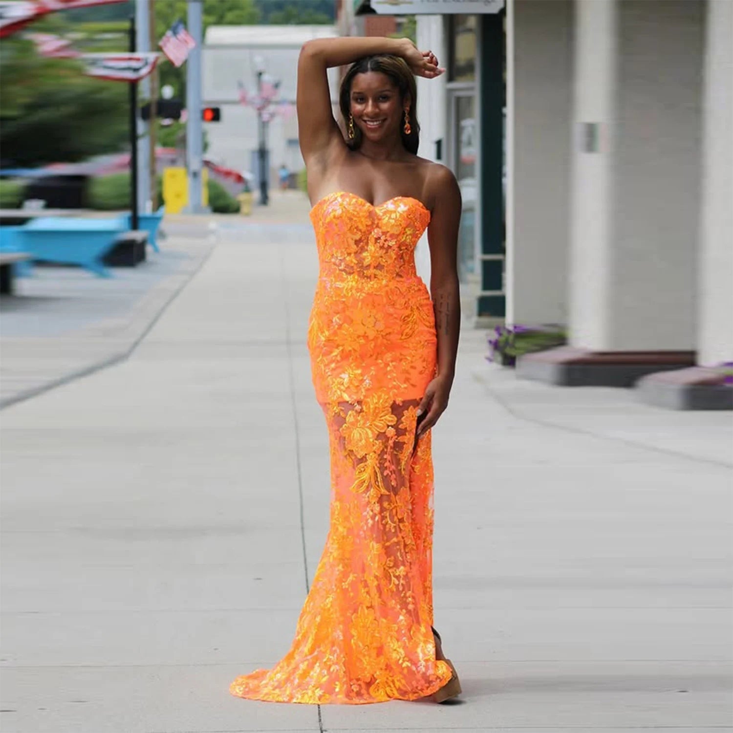 Sunset Glow Strapless Gown in orange lace, showcasing a mermaid silhouette and sweetheart neckline.