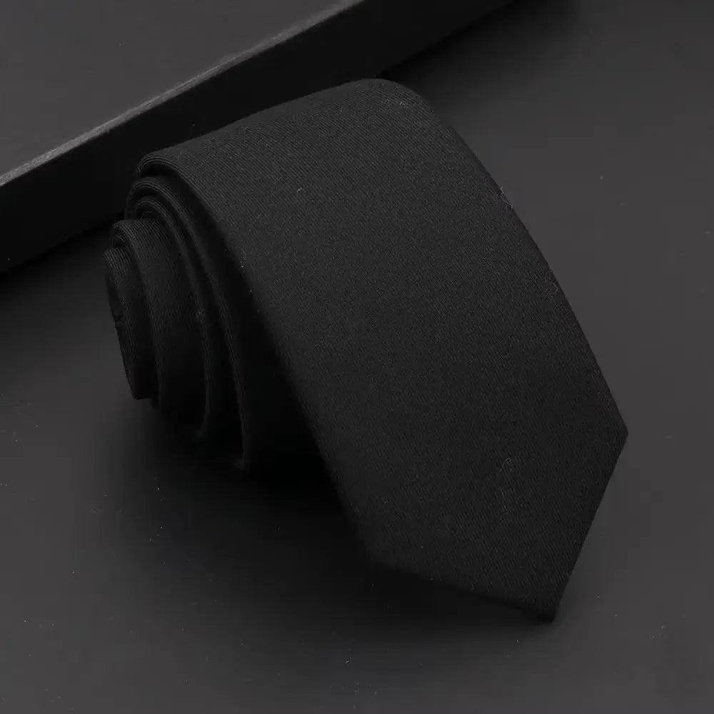 Handmade black tie, a staple accessory for commanding first impressions.