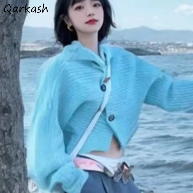 Whisper-Soft Cardigan in soft beige, crafted from cotton, wool, and polyester blend for warmth and style.
